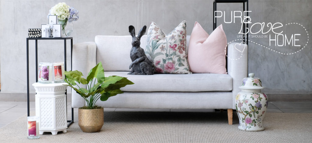 Pure Love Home Styled Setting with furniture and decor against a grey wall
